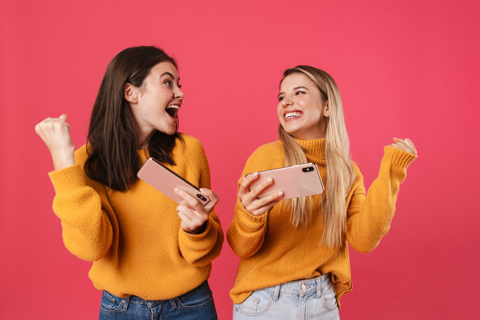 Two Happy Pretty Girls Celebrating Success